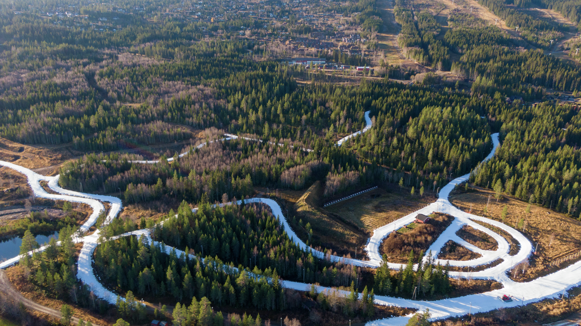 View of a cross country tracks with surrounded by forest and mountains in the background, in a scenic setting in Trysil